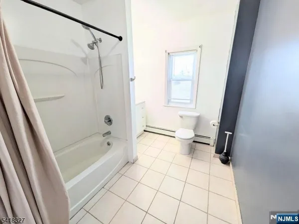 a bathroom with a bathtub a toilet and a shower