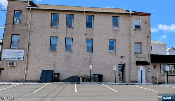 a couple of cars parked in front of brick building