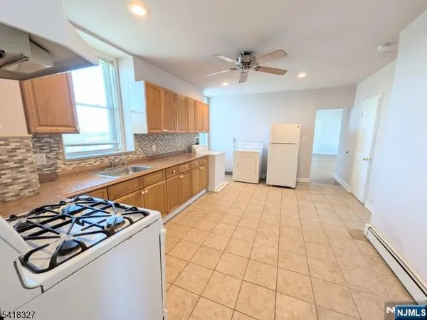 a kitchen with a stove a sink and a refrigerator