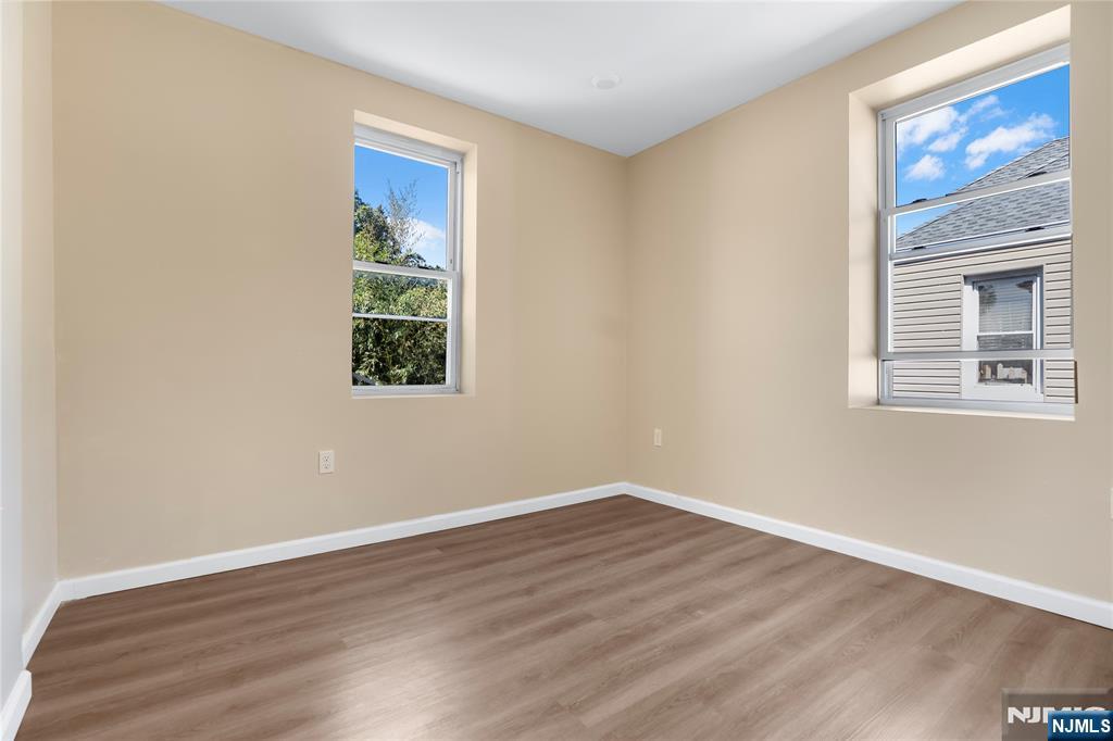 183 Bergen Turnpike Ridgefield Park, NJ 07660 - Photo 13 of 18 a view of an empty room with wooden floor and a window