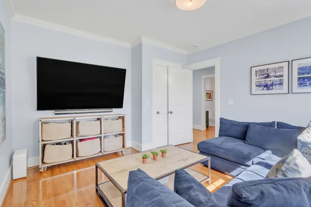 a spacious bedroom with a bed and wooden floor