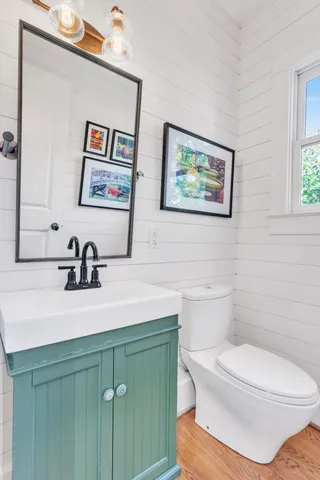 a spacious bedroom with a bed a couch and a large window