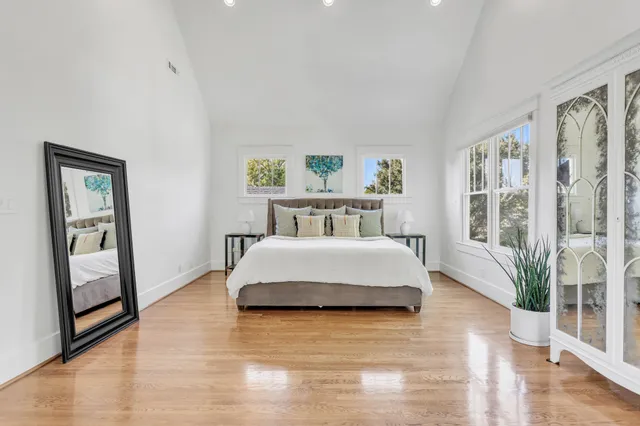 a bedroom with a bed window and couch