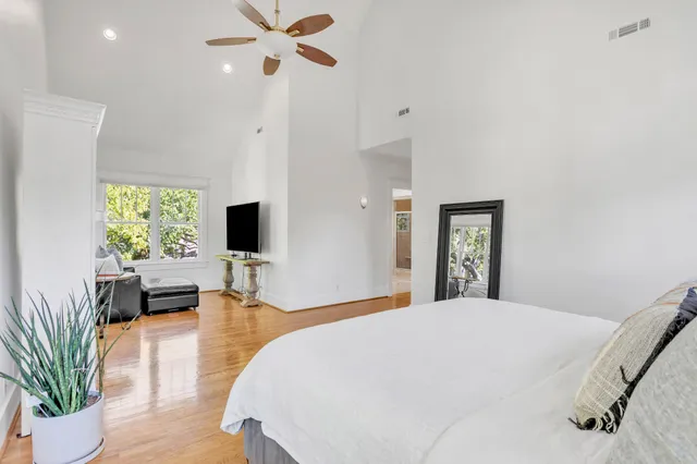 a spacious bathroom with a granite countertop sink a mirror and a shower