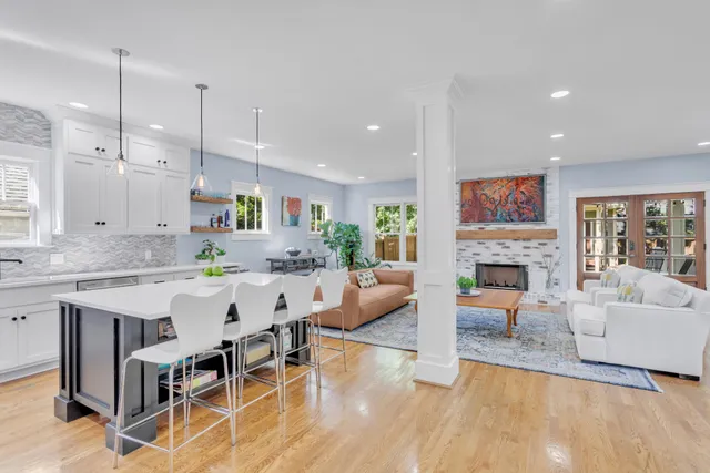 a large white kitchen with a table and chairs