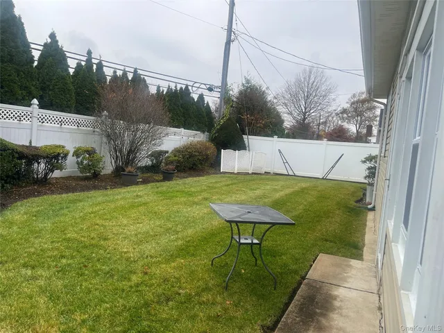 a view of a backyard with sitting area