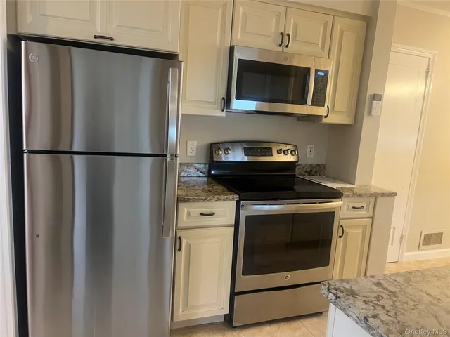 a kitchen with appliances and cabinets