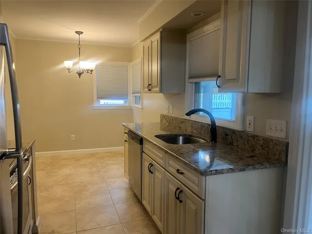 a kitchen with stainless steel appliances granite countertop a sink stove and cabinets
