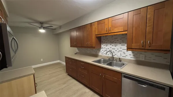 a kitchen with a sink cabinets and window