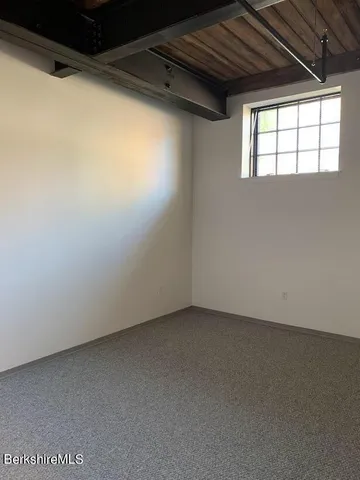a bathroom with a shower and a white toilet