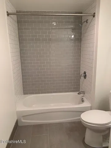 a bathroom with a toilet sink and shower