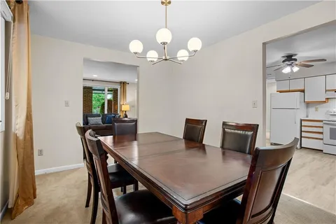 a view of a dining room with a table and chairs