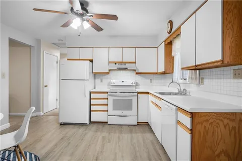 a kitchen with a refrigerator a sink and dishwasher
