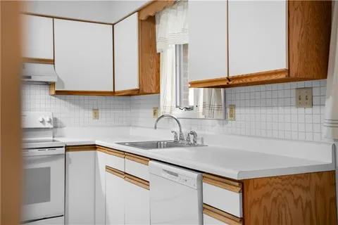 a kitchen with a sink and a refrigerator