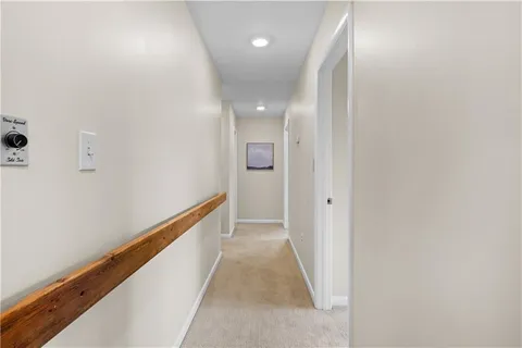 a view of hallway with wooden floor