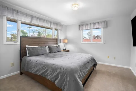 a spacious bedroom with a bed and window