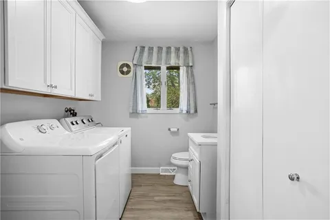 a bathroom with a sink a toilet and a window