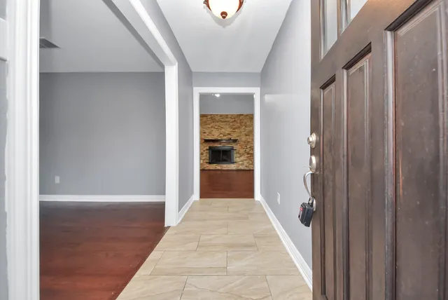 a view of a hallway with wooden floor and staircase