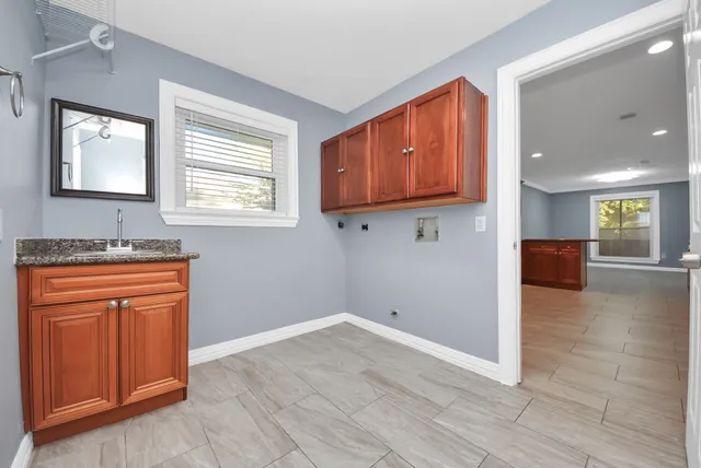 a large kitchen with stainless steel appliances granite countertop a stove a sink and a granite counter tops