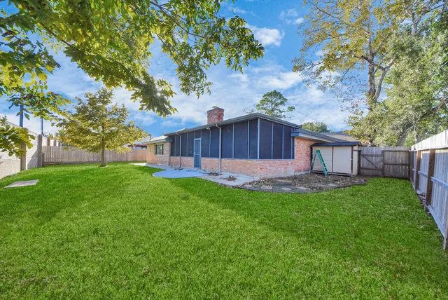 a backyard of a house with table and chairs