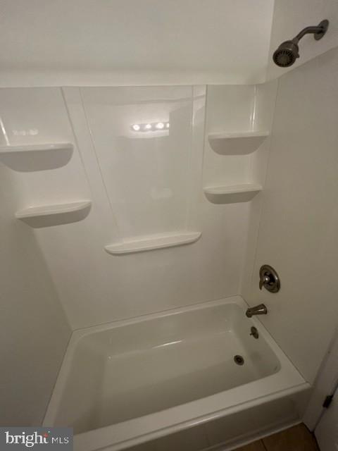 830 Heather Ridge Drive, Unit 22C Frederick, MD 21702 - Photo 14 of 22 Modern bathroom with sleek tub and shelves.
