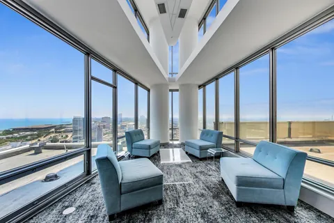 a living room with furniture and floor to ceiling window