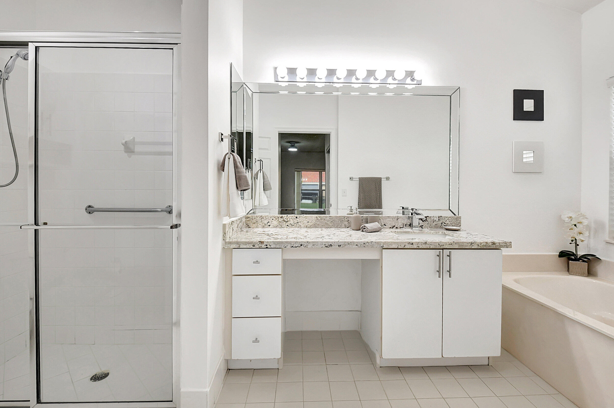 6340 Long Key Lane Boynton Beach, FL 33472 - Photo 11 of 29 a bathroom with a granite countertop sink a mirror and a bathtub