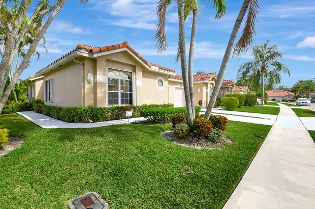 a view of a house with a yard and plants