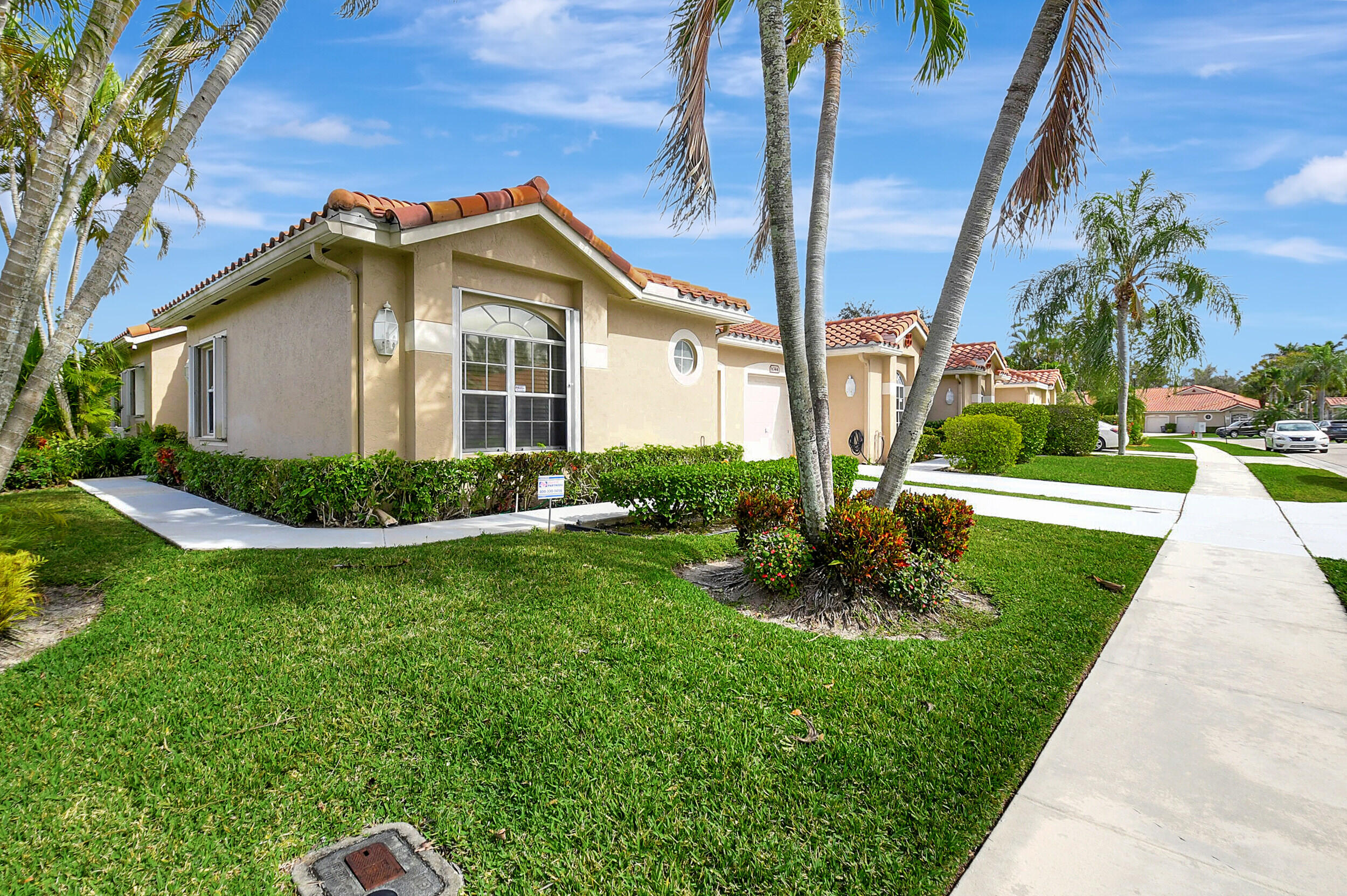 6340 Long Key Lane Boynton Beach, FL 33472 - Photo 2 of 29 a view of a house with a yard and plants