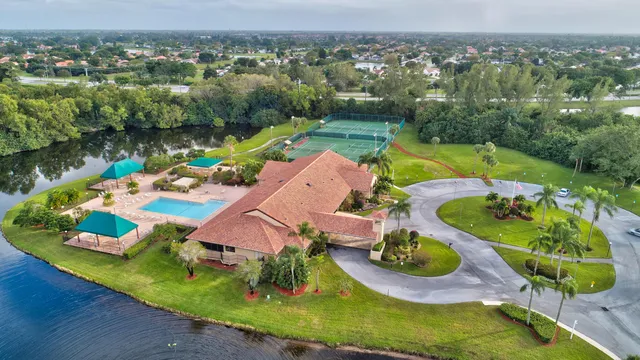 an aerial view of a house with a swimming pool yard and outdoor seating