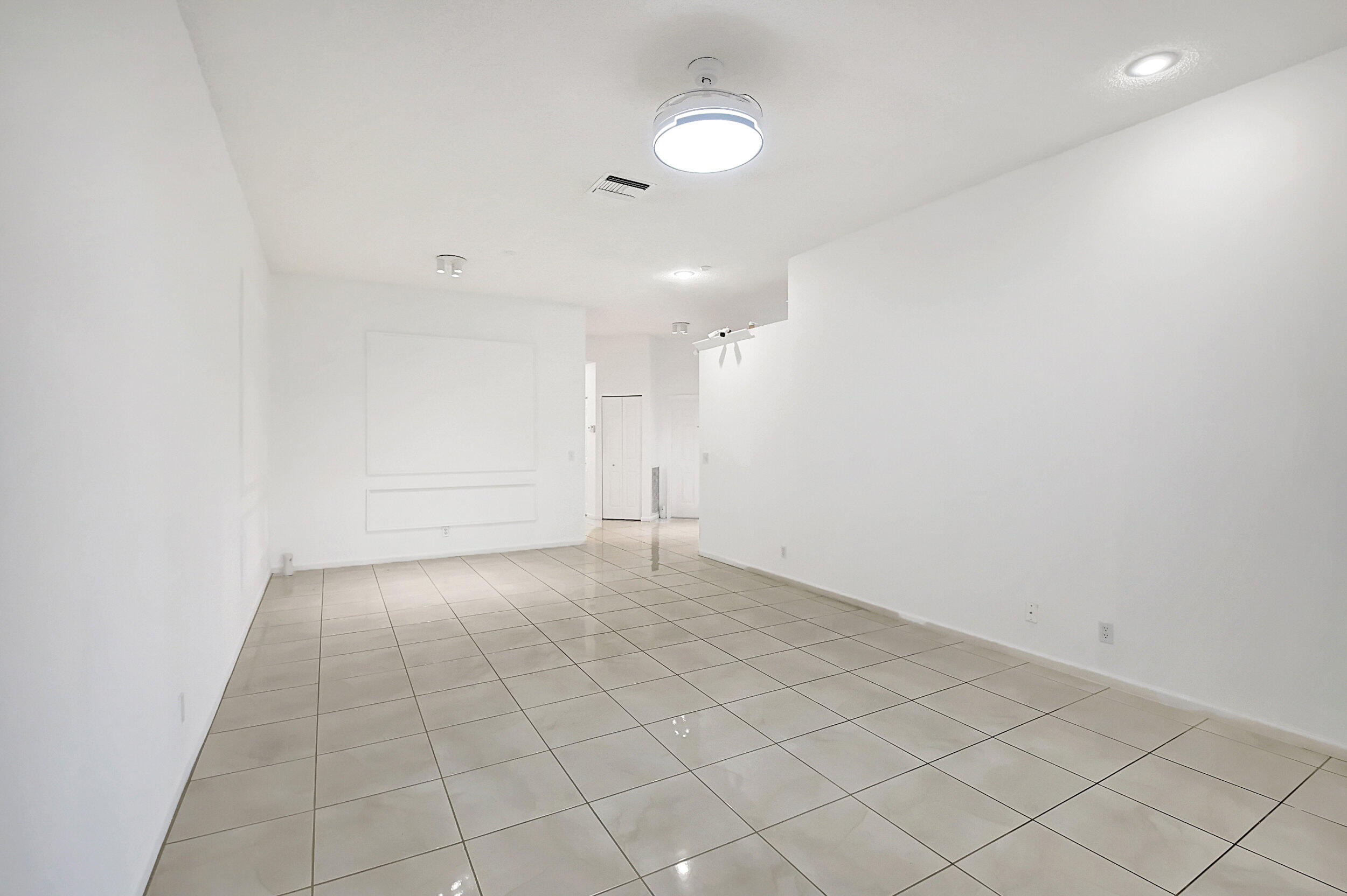 6340 Long Key Lane Boynton Beach, FL 33472 - Photo 8 of 29 an empty room with white walls and tiles