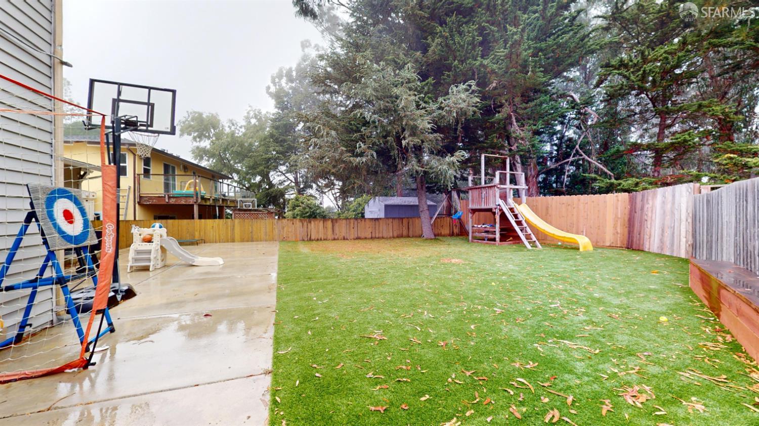 1155 Crespi Drive Pacifica, CA 94044 - Photo 22 of 29 fenced backyard with a playground and artificial grass