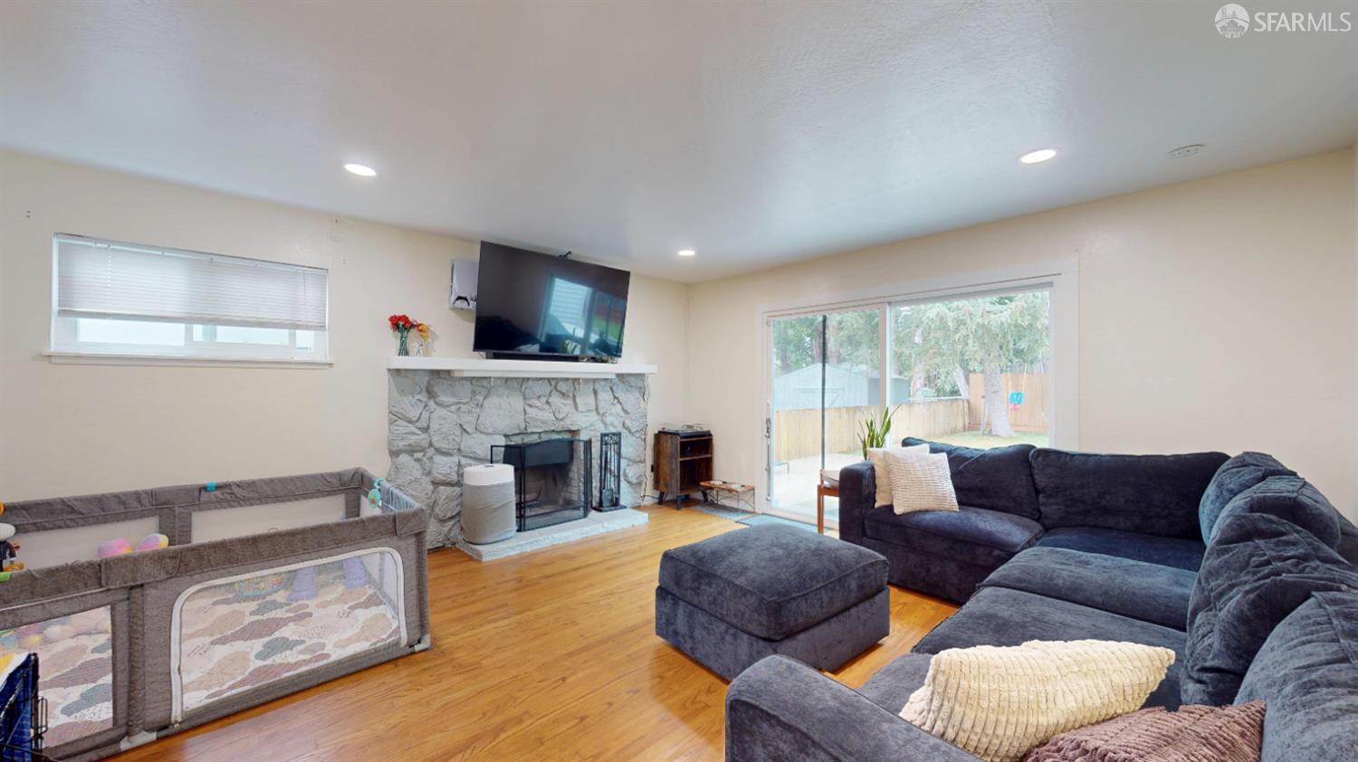1155 Crespi Drive Pacifica, CA 94044 - Photo 3 of 29 living room with original hardwood finished floors, a wood fireplace, plenty of natural light, and recessed lighting
