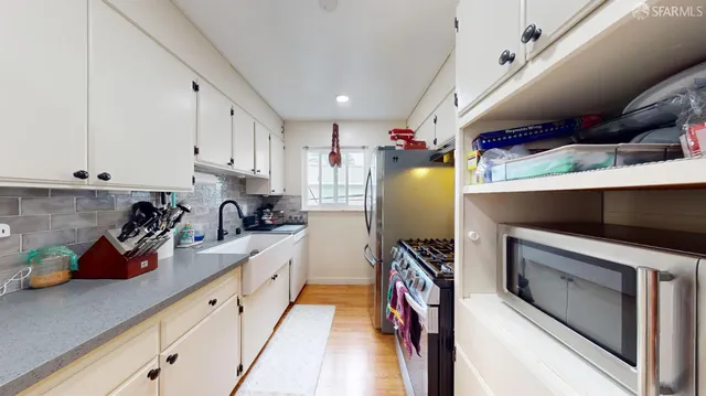 a kitchen with refrigerator and cabinets