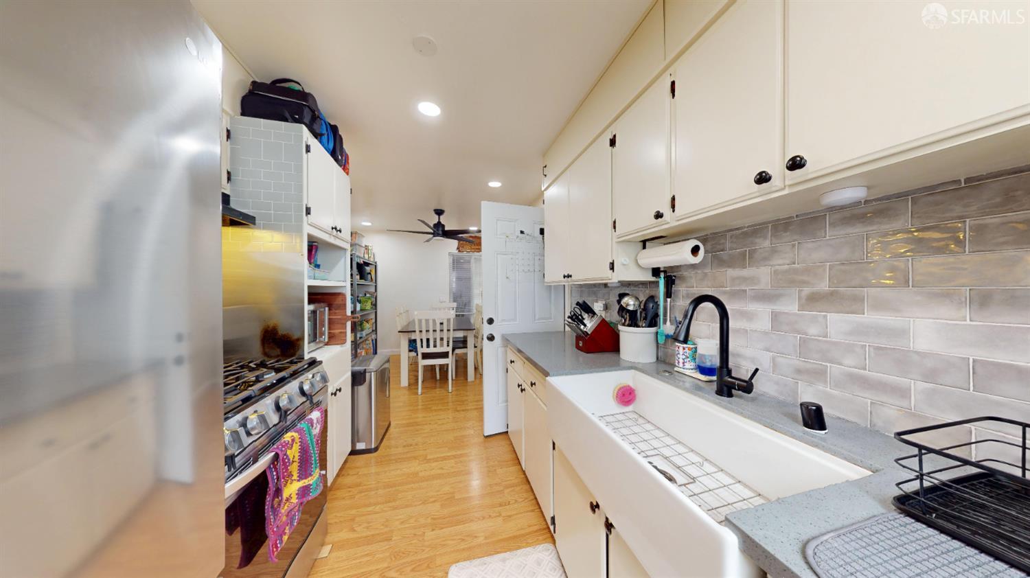 1155 Crespi Drive Pacifica, CA 94044 - Photo 6 of 29 kitchen with tasteful backsplash, stainless steel appliances, vinyl floors, recessed lighting, and white cabinets