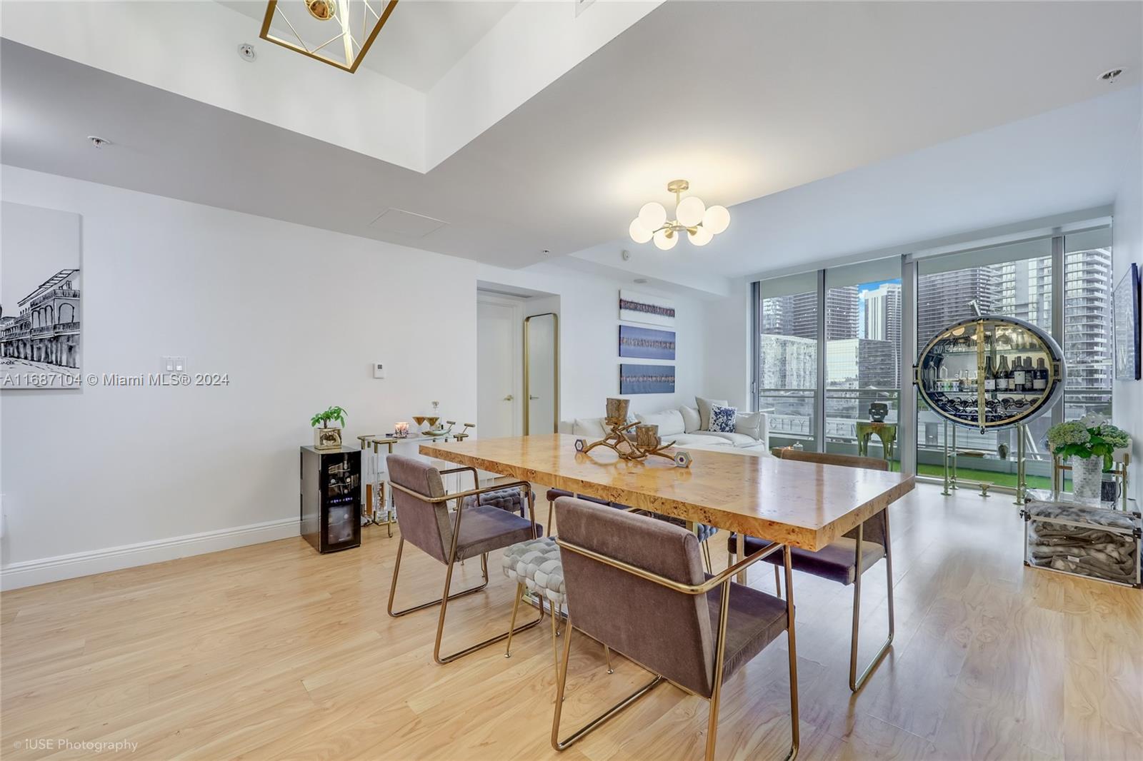 92 Southwest 3rd Street, Unit 1604 Miami, FL 33130 - Photo 11 of 18 a dining room with furniture a chandelier and wooden floor