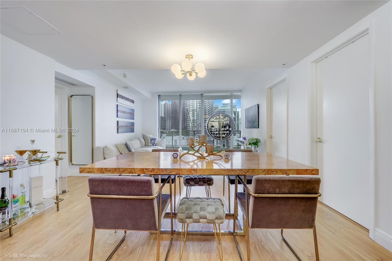 92 Southwest 3rd Street, Unit 1604 Miami, FL 33130 - Photo 12 of 18 a view of a dining room with furniture and wooden floor