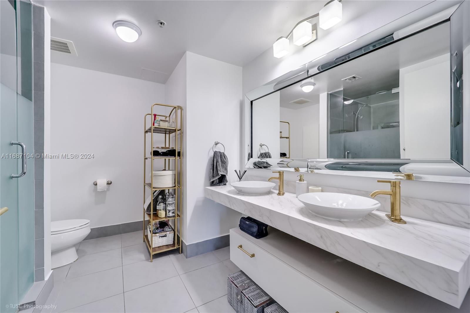 92 Southwest 3rd Street, Unit 1604 Miami, FL 33130 - Photo 7 of 18 a bathroom with a sink double vanity and a toilet