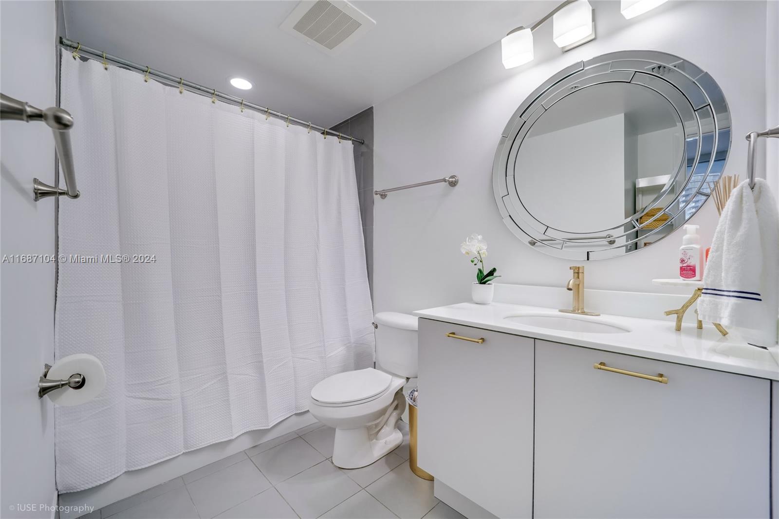 92 Southwest 3rd Street, Unit 1604 Miami, FL 33130 - Photo 10 of 18 a bathroom with a sink a toilet and a mirror