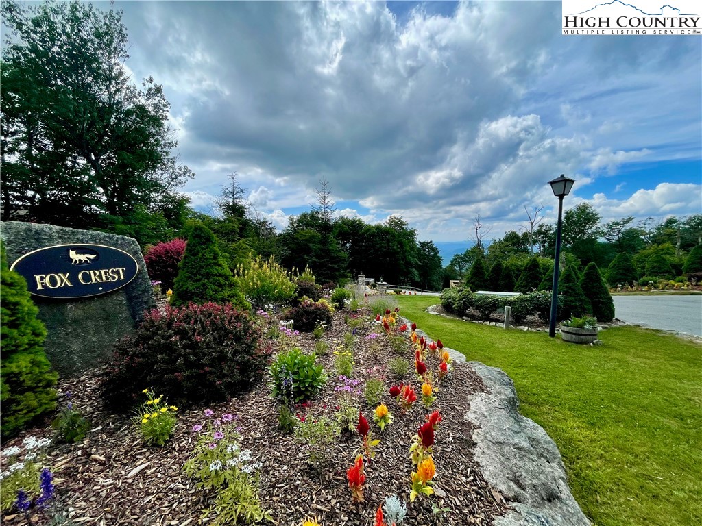 Fox Crest Road Beech Mountain, NC 28604 - Photo 21 of 21 a view of a garden with a lot of flower plants and wooden fence