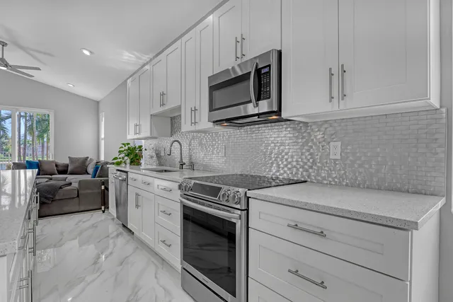 a living room with furniture and kitchen view