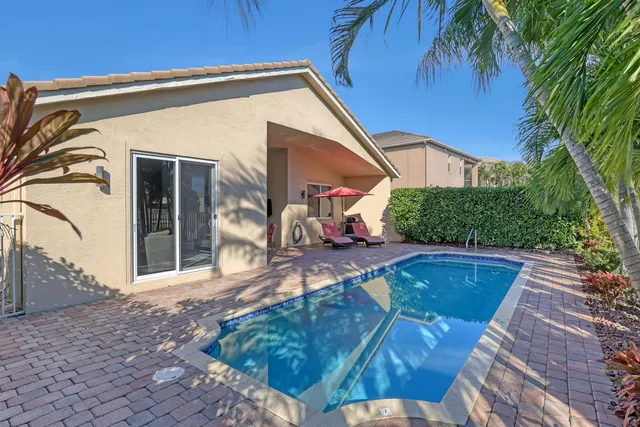 a swimming pool with outdoor seating and yard