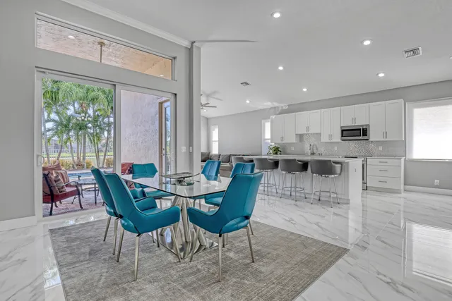 a kitchen with granite countertop white cabinets stainless steel appliances and a sink