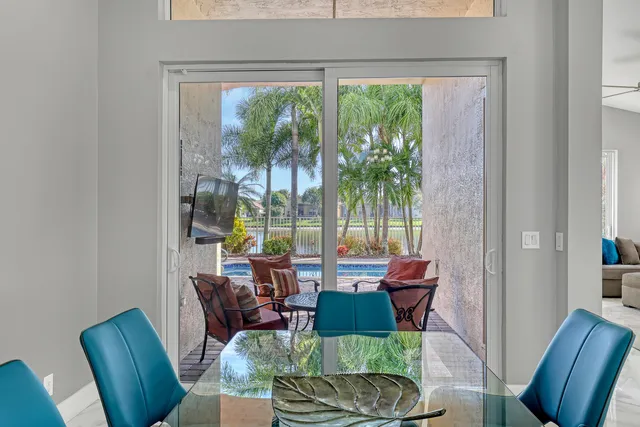 a kitchen with white cabinets and window