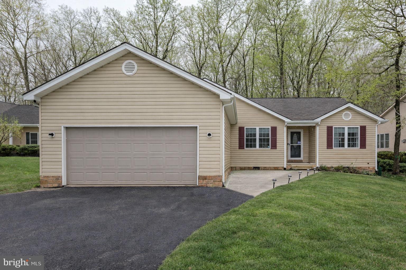 a view of a yard in front view of a house