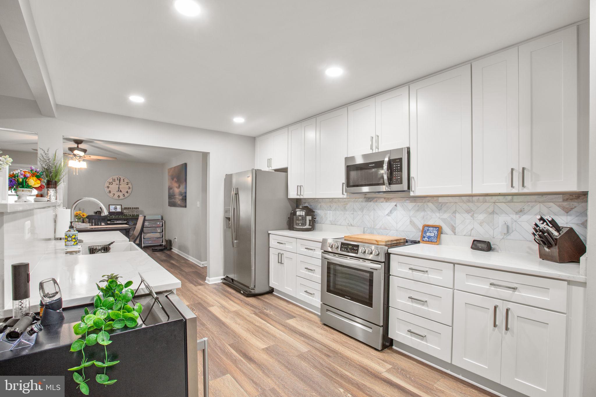 114 Saylers Creek Road Locust Grove, VA 22508 - Photo 12 of 32 a kitchen with white cabinets and stainless steel appliances