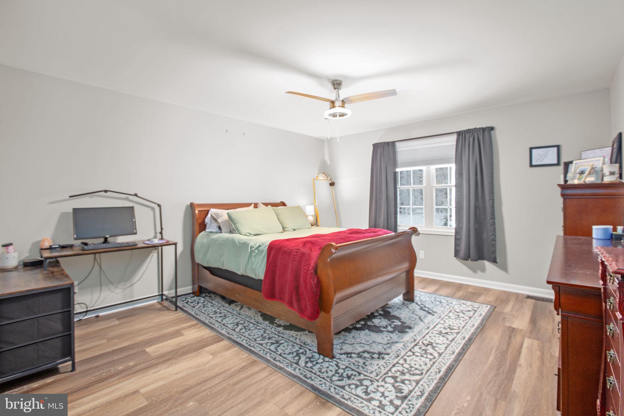 114 Saylers Creek Road Locust Grove, VA 22508 - Photo 16 of 32 a bedroom with a bed and wooden floor
