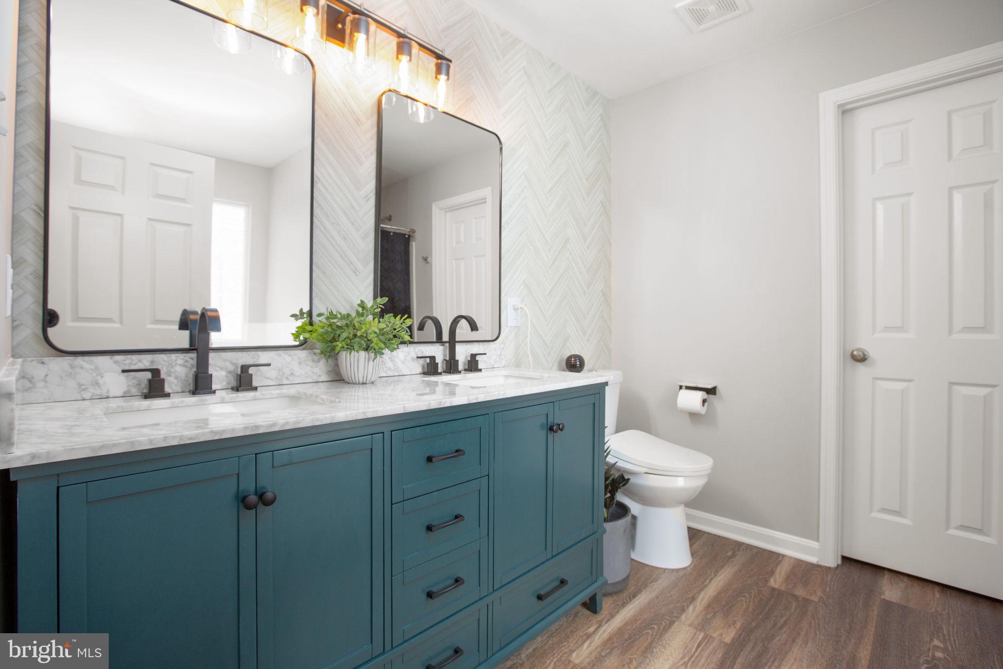 114 Saylers Creek Road Locust Grove, VA 22508 - Photo 19 of 32 a bathroom with a double vanity sink toilet and mirror