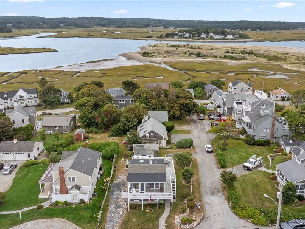 an aerial view of residential building with outdoor space and ocean view