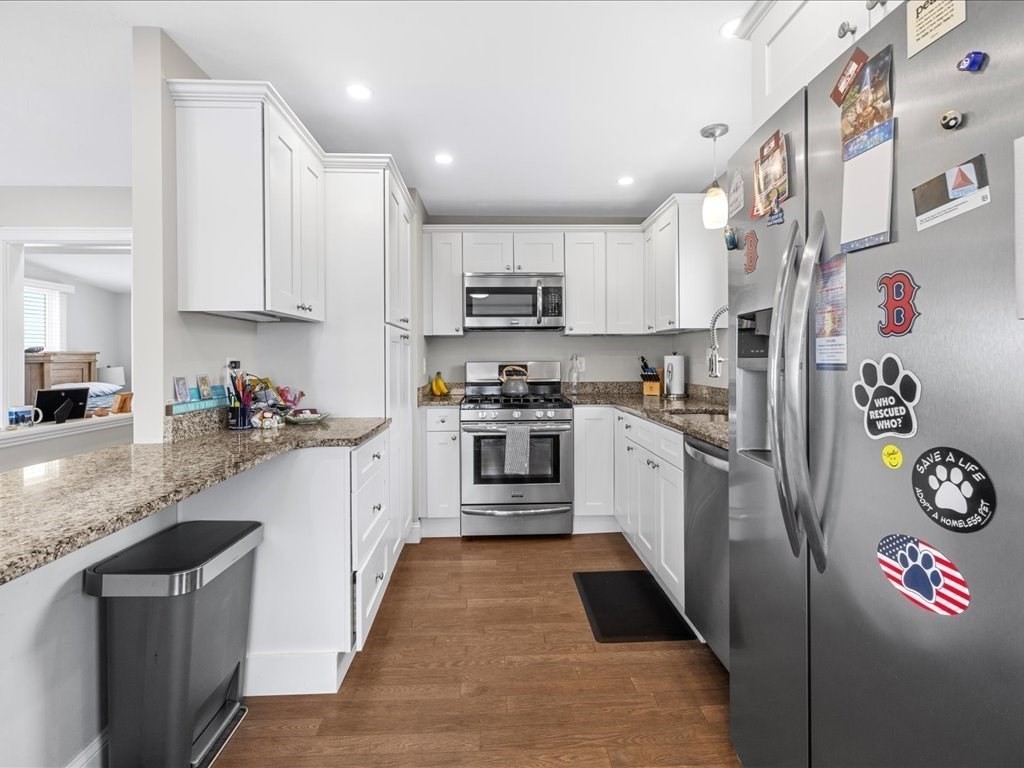 35 Cliff Road South Scituate, MA 02050 - Photo 7 of 42 a kitchen with granite countertop a refrigerator and a stove top oven